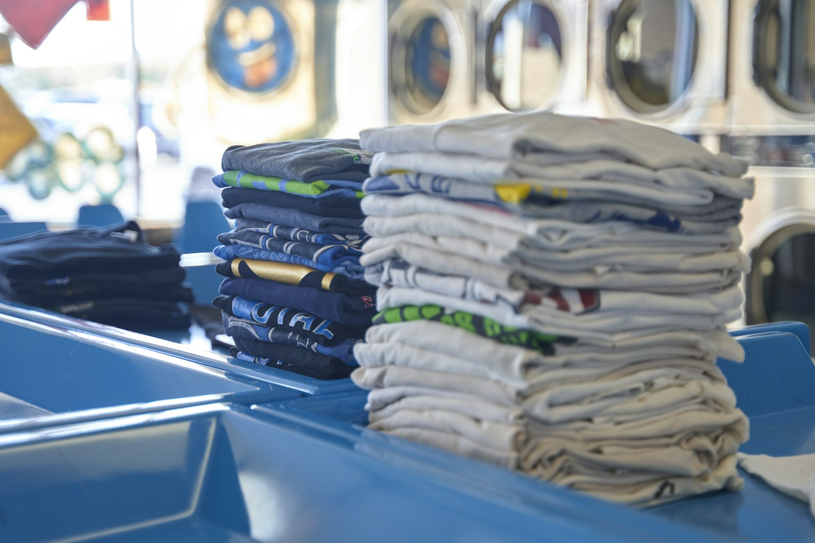 Stack of neatly folded white shirts on a surface